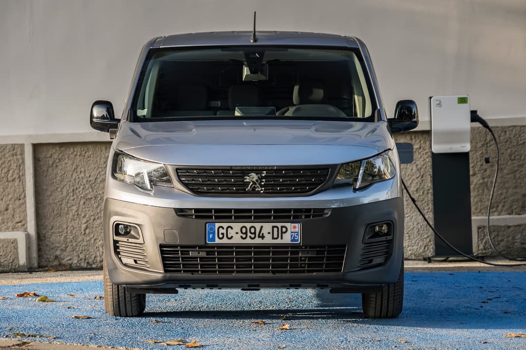 Peugeot e-Partner van charging from AC charger front view Peugeot e-Partner van charging from AC charger front view