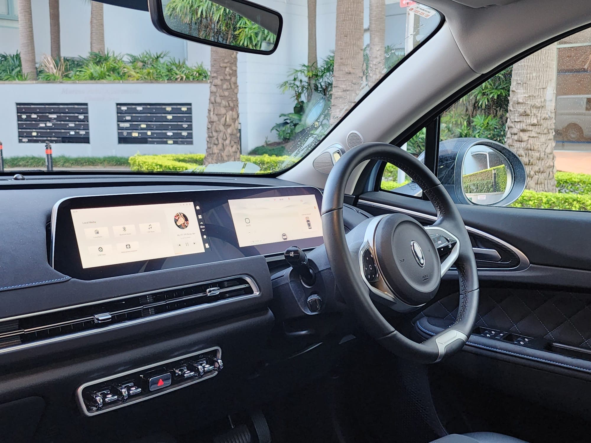 GWM Ora interior showing blue-stitched faux leather seats and dual 10.25-inch screens GWM Ora interior showing blue-stitched faux leather seats and dual 10.25-inch screens