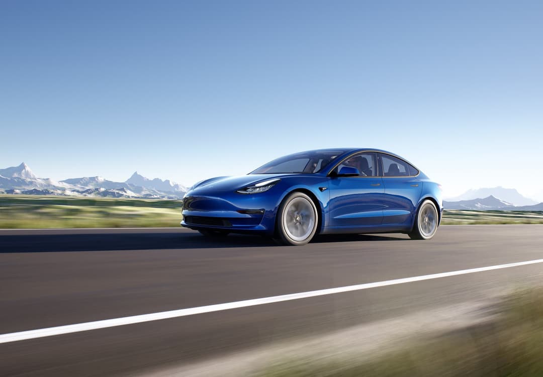Blue Tesla Model 3 driving Blue Tesla Model 3 driving