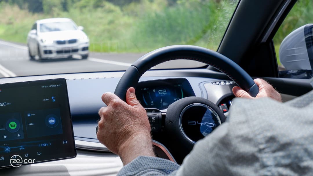 Man driving BYD Atto 3 interior steering wheel view Man driving BYD Atto 3 interior steering wheel view