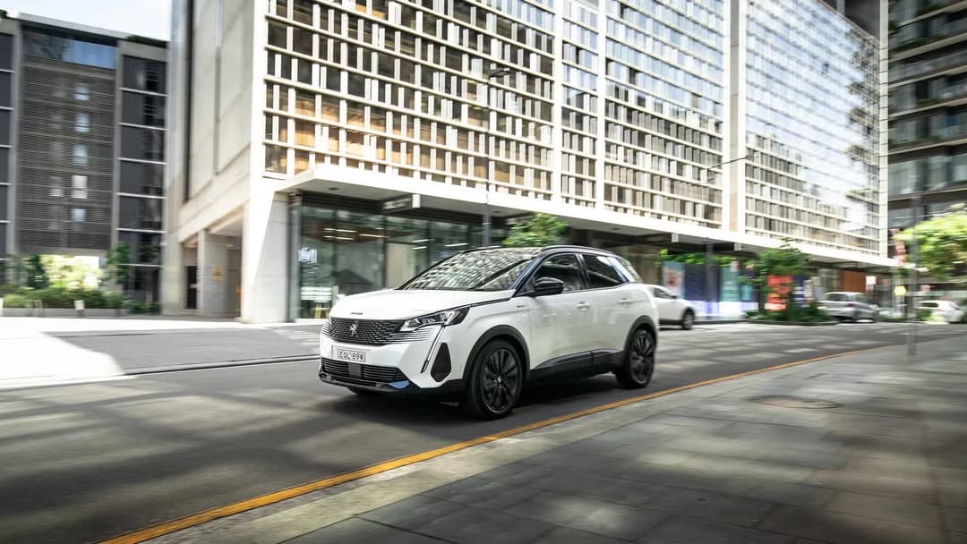 Peugeot 3008 in white driving in the city Peugeot 3008 in white driving in the city