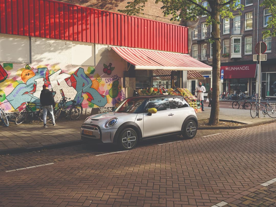 Mini Electric parked on the side of an urban street Mini Electric parked on the side of an urban street