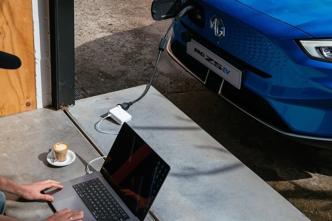 Laptop being charged by MG ZS EV V2L connector accessory Laptop being charged by MG ZS EV V2L connector accessory
