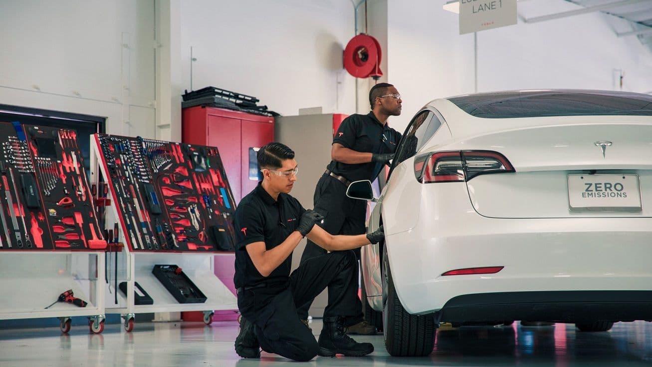 Tesla Model 3 being serviced in workshop Tesla Model 3 being serviced in workshop