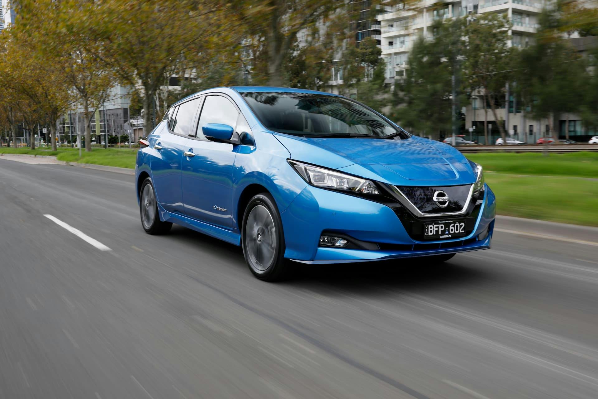 Blue Nissan Leaf e+ driving in city