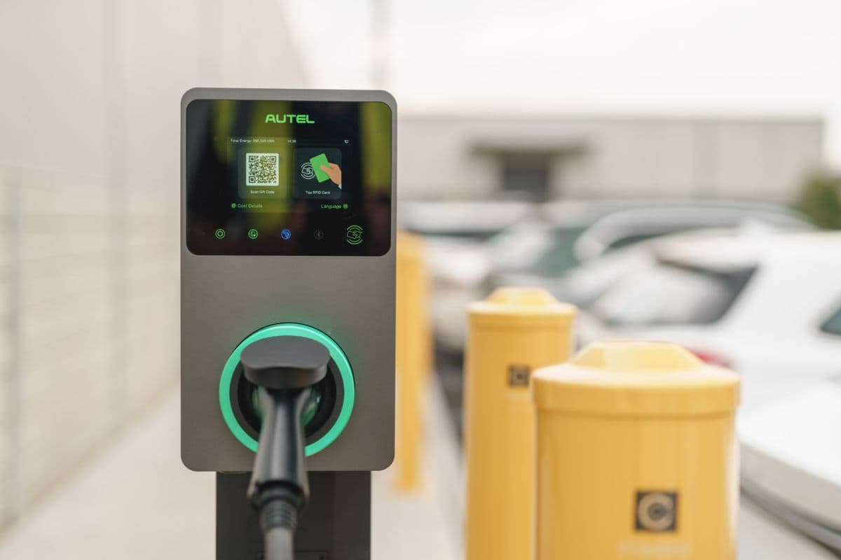 Autel MaxiCharger AC commercial EV charger on a pedestal in a car park Autel MaxiCharger AC commercial EV charger on a pedestal in a car park