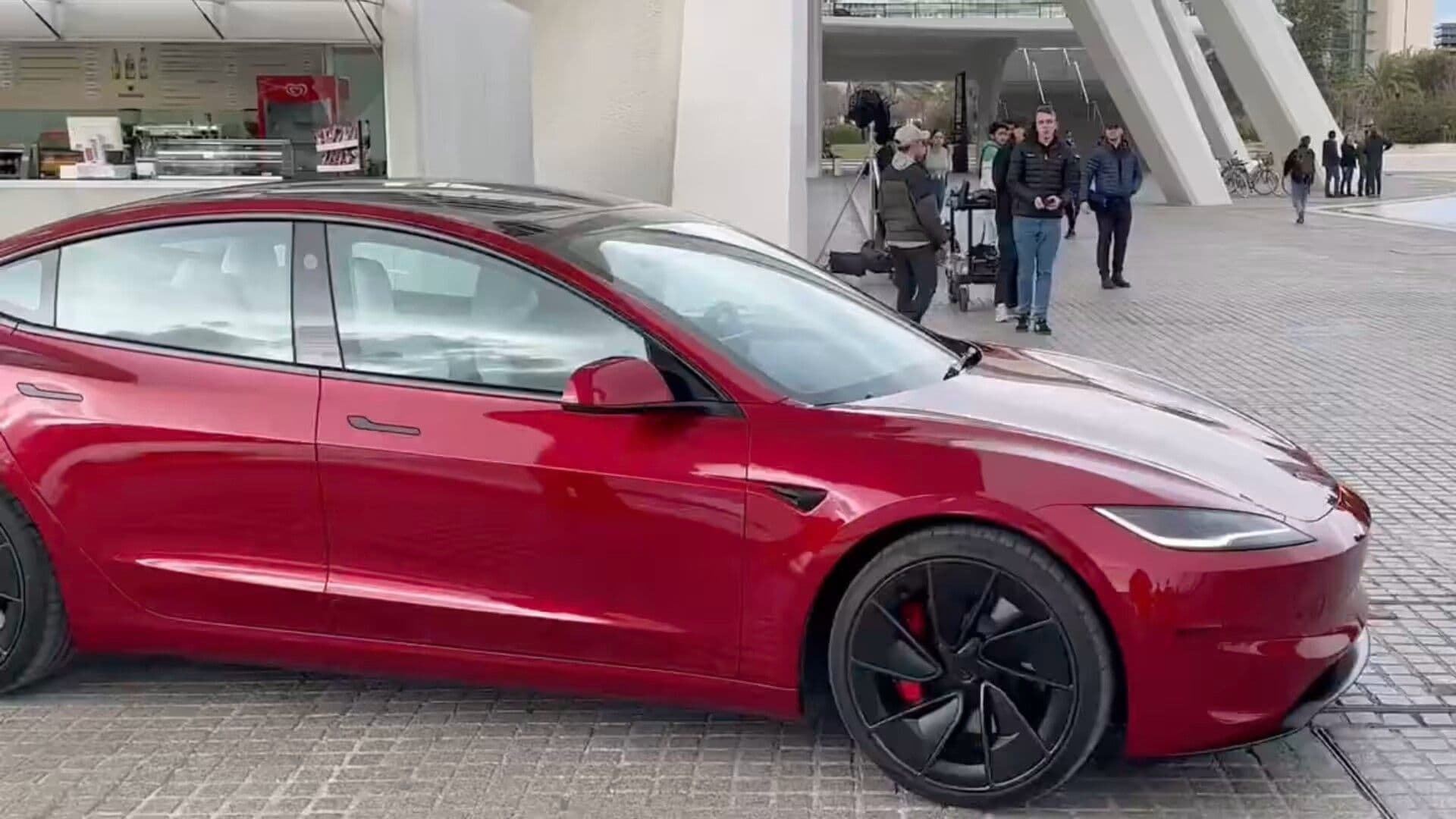2024 Tesla Model 3 Performance in red parked side view leak photo 2024 Tesla Model 3 Performance in red parked side view leak photo